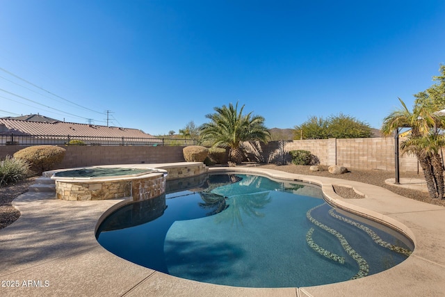 view of swimming pool with an in ground hot tub