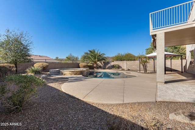 view of swimming pool with a gazebo, an in ground hot tub, and a patio