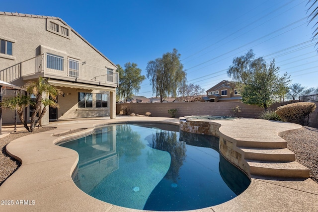 view of swimming pool featuring a patio and an in ground hot tub