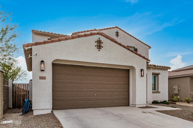 mediterranean / spanish house with a garage