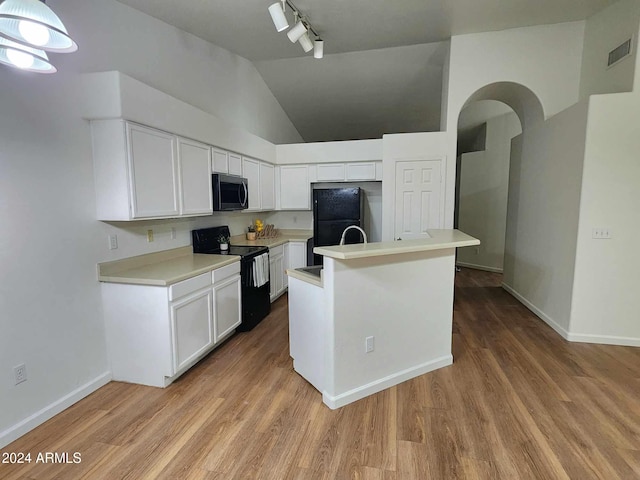 kitchen featuring black appliances, rail lighting, light wood-type flooring, decorative light fixtures, and white cabinetry