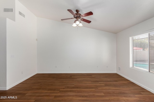 empty room with dark hardwood / wood-style flooring, ceiling fan, and lofted ceiling