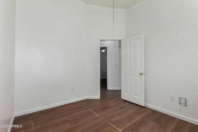 unfurnished room featuring ceiling fan and dark hardwood / wood-style floors