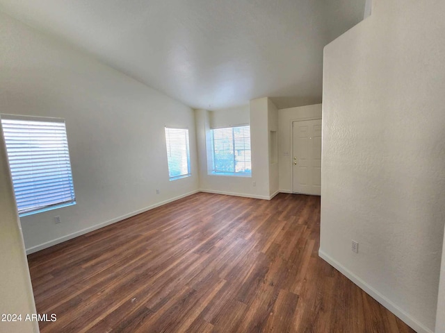 empty room with dark hardwood / wood-style flooring