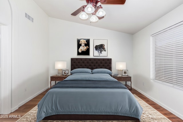 bedroom featuring ceiling fan, dark hardwood / wood-style flooring, and lofted ceiling