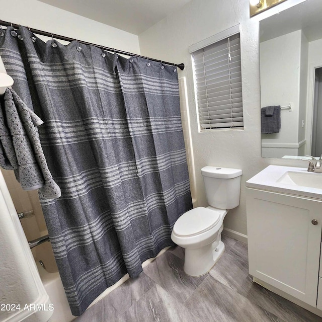 full bathroom with vanity, toilet, and shower / bath combo with shower curtain