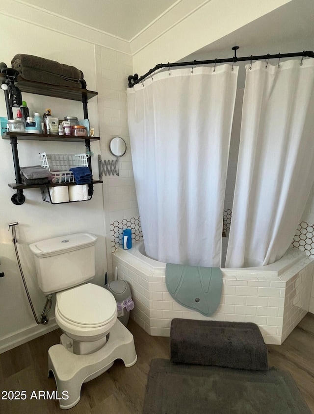 bathroom with toilet, shower / bath combo, and wood-type flooring