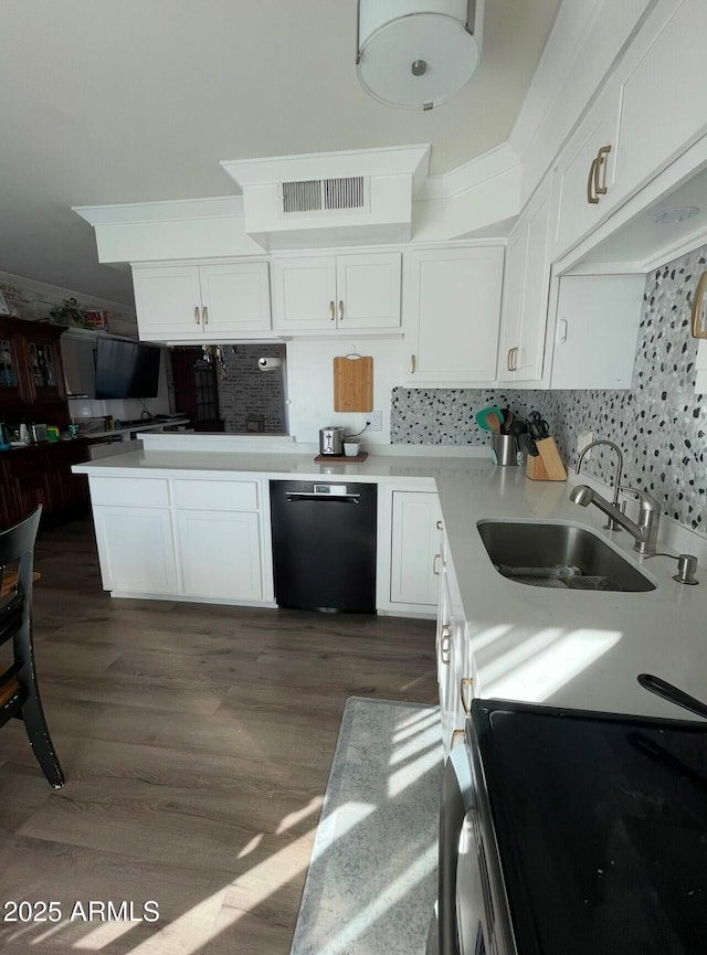 kitchen with sink, backsplash, white cabinetry, and dishwasher