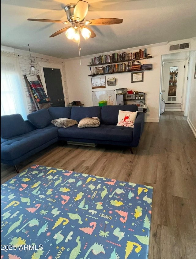 living room with wood-type flooring and ceiling fan