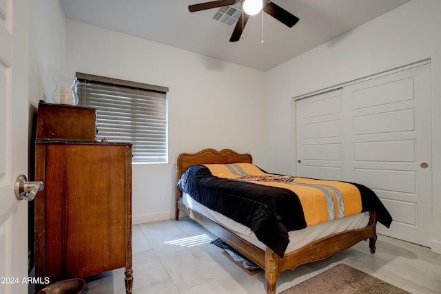 tiled bedroom with a closet and ceiling fan