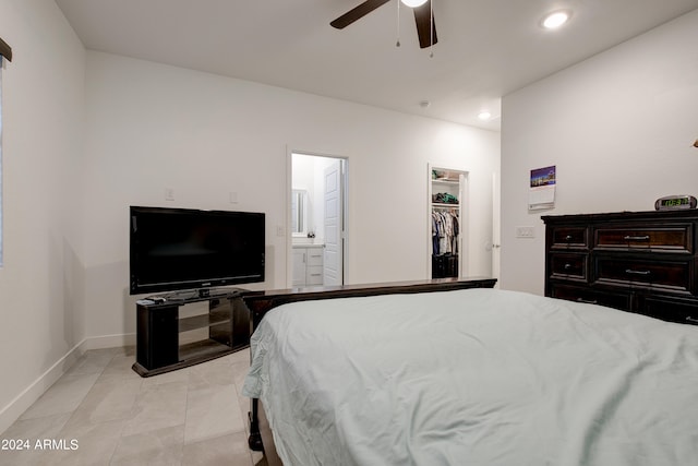 bedroom with ceiling fan, a closet, light tile patterned flooring, a walk in closet, and ensuite bathroom