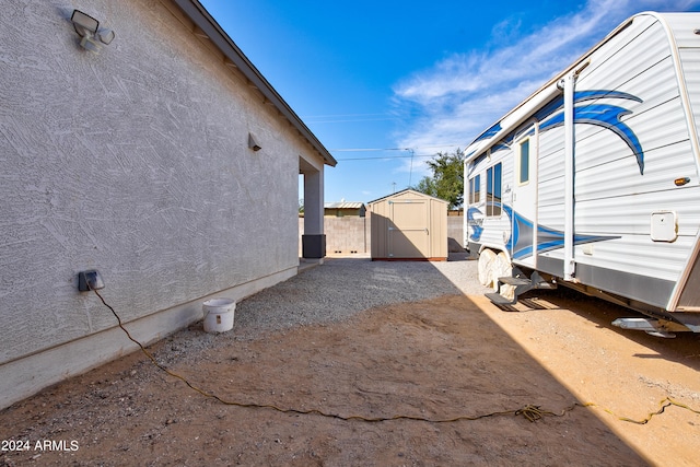 view of home's exterior with a storage shed