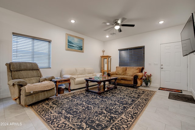 living room with ceiling fan and light tile patterned flooring