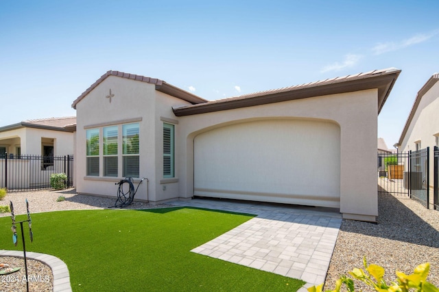 view of front of property with a tile roof, fence, a patio, and stucco siding