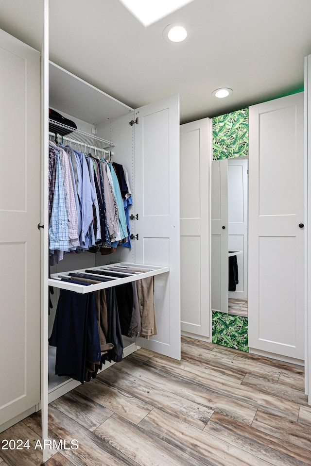 walk in closet featuring light hardwood / wood-style floors