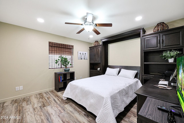 bedroom with ceiling fan and light hardwood / wood-style flooring