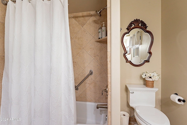 bathroom featuring shower / tub combo and toilet