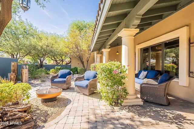 view of patio featuring an outdoor living space with a fire pit