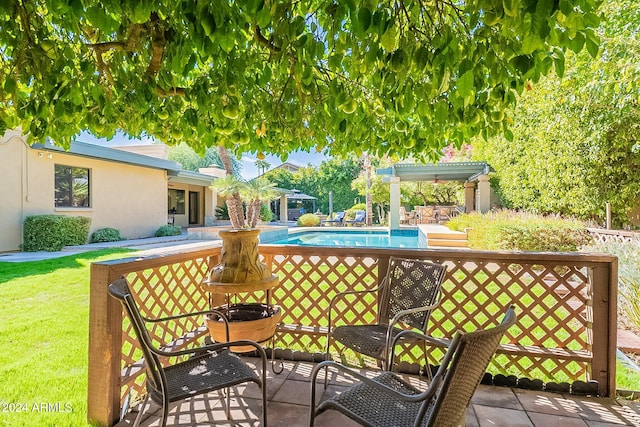 wooden deck with a patio and a yard