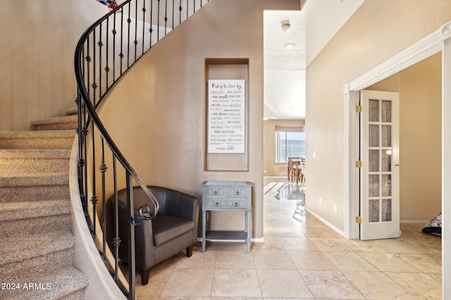 stairway featuring tile patterned floors