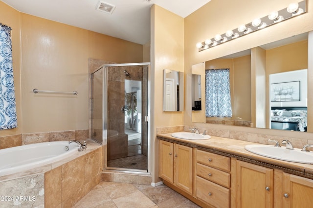 bathroom with independent shower and bath, vanity, and tile patterned flooring