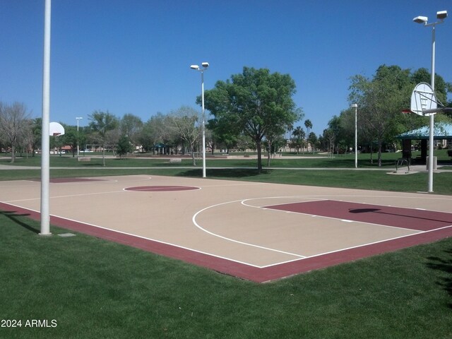 view of sport court featuring a lawn