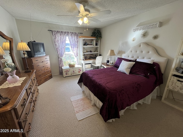 bedroom featuring light carpet, ceiling fan, and a textured ceiling