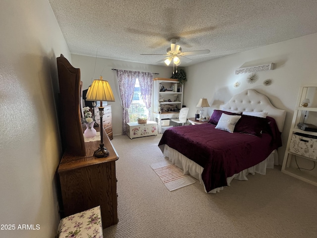 bedroom with ceiling fan, a textured ceiling, and carpet flooring