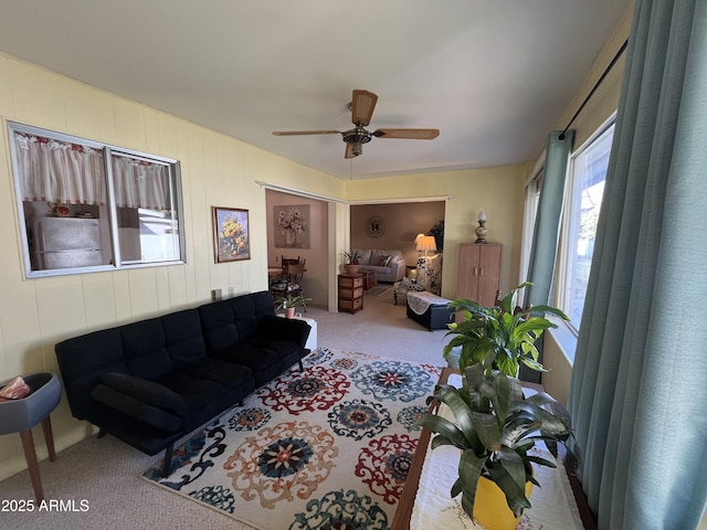 carpeted living room featuring ceiling fan