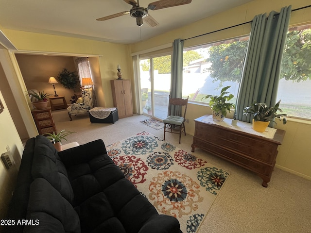 carpeted living room with ceiling fan