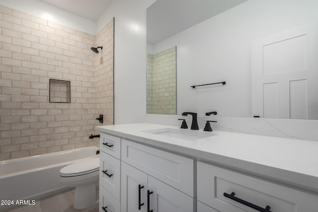 full bathroom with tile patterned floors, vanity, toilet, and tiled shower / bath combo