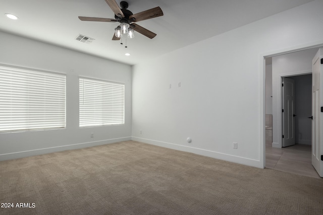 carpeted spare room with ceiling fan