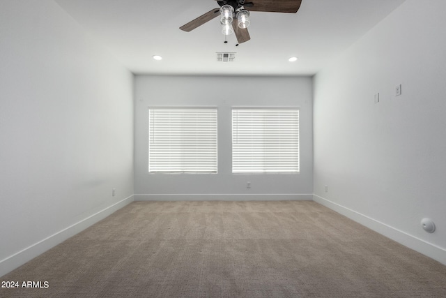 unfurnished room with light carpet and ceiling fan