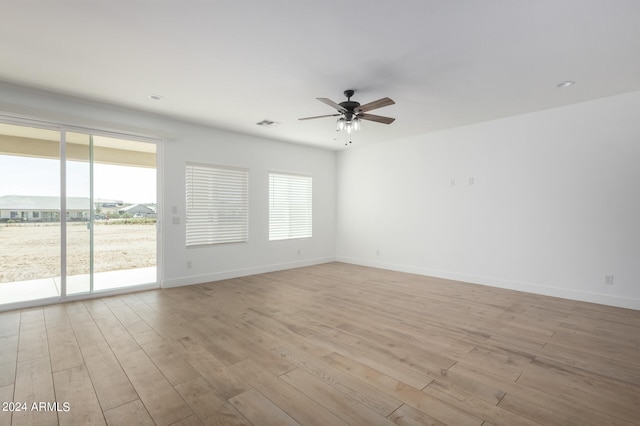 spare room featuring light hardwood / wood-style flooring and ceiling fan