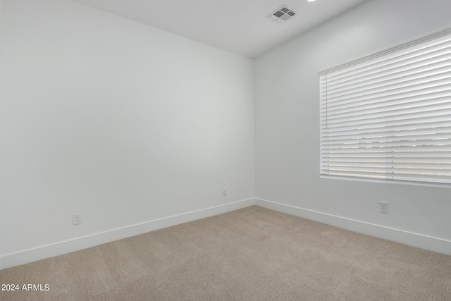 spare room with light colored carpet