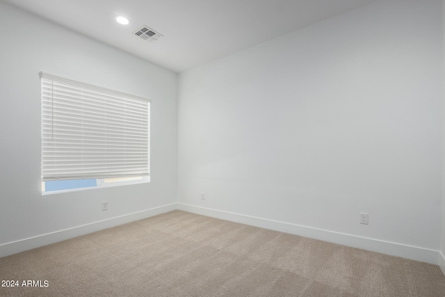 empty room featuring light colored carpet