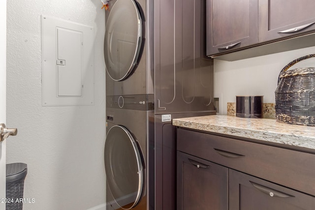 14950 W Mountain View Blvd Unit 4205, Surprise, AZ 85374 - laundry room featuring stacked washer / dryer, cabinet space, and electric panel