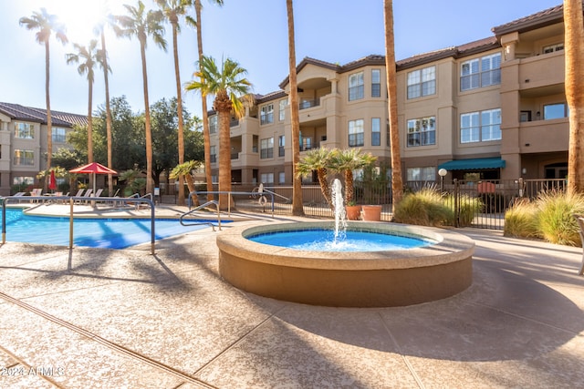 view of swimming pool with pool water feature