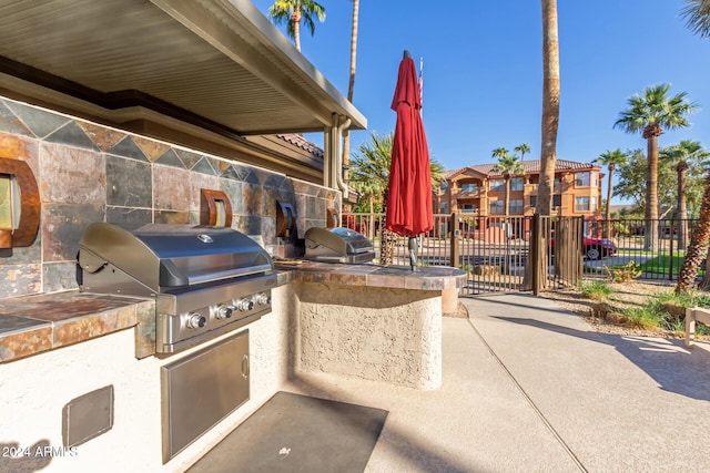 14950 W Mountain View Blvd Unit 4205, Surprise, AZ 85374 - view of patio / terrace with area for grilling, fence, and exterior kitchen
