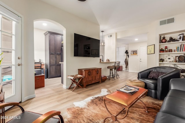 14950 W Mountain View Blvd Unit 4205, Surprise, AZ 85374 - living room with light wood-style floors, arched walkways, and baseboards