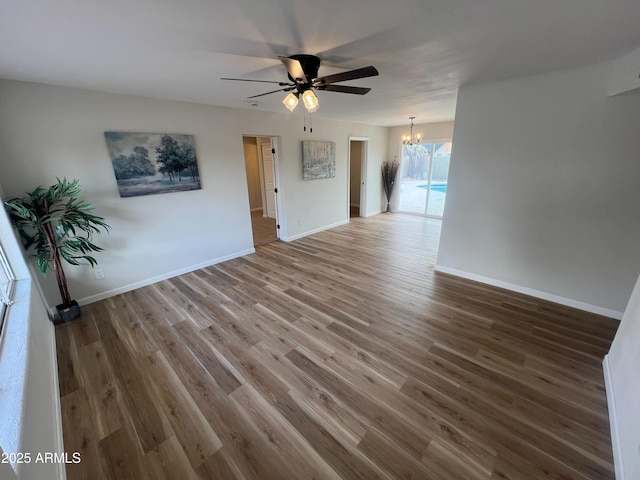 1545 W Marco Polo Rd, Phoenix, AZ 85027 - spare room featuring a chandelier, ceiling fan, wood finished floors, and baseboards