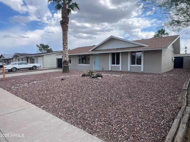 1545 W Marco Polo Rd, Phoenix, AZ 85027 - ranch-style home featuring a shingled roof, a porch, brick siding, and driveway