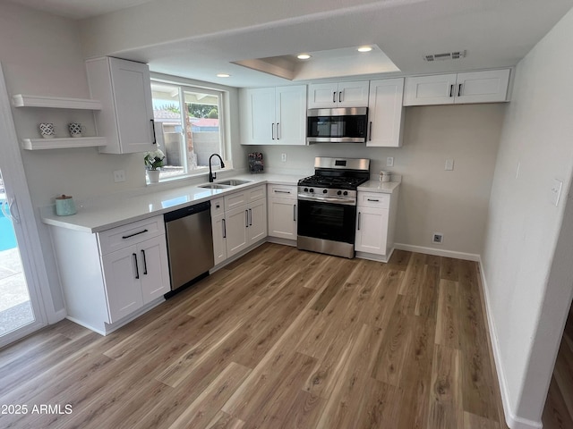 1545 W Marco Polo Rd, Phoenix, AZ 85027 - kitchen with appliances with stainless steel finishes, a sink, open shelves, white cabinetry, and recessed lighting