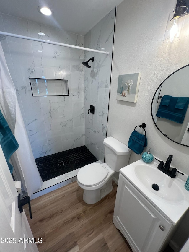 1545 W Marco Polo Rd, Phoenix, AZ 85027 - full bathroom featuring a shower stall, toilet, wood finished floors, and vanity