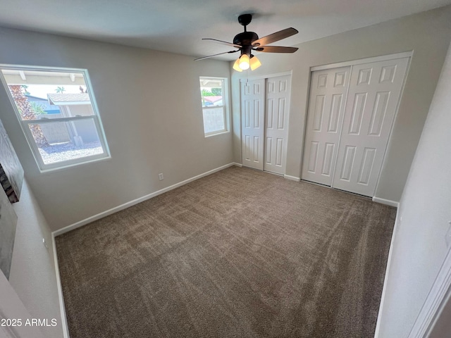 1545 W Marco Polo Rd, Phoenix, AZ 85027 - unfurnished bedroom with multiple closets, carpet flooring, baseboards, and a ceiling fan
