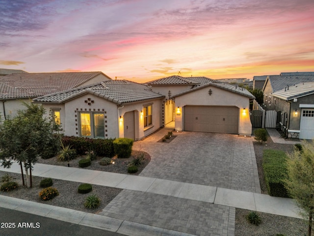 10006 E Rotation Dr, Mesa, AZ 85212 - mediterranean / spanish-style home featuring stucco siding, a gate, a garage, decorative driveway, and a tiled roof