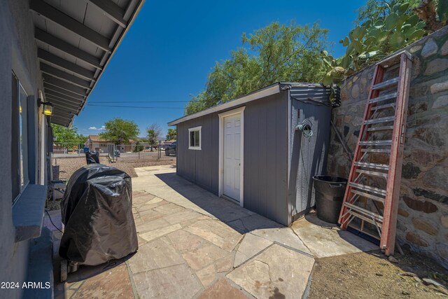 view of patio featuring a shed