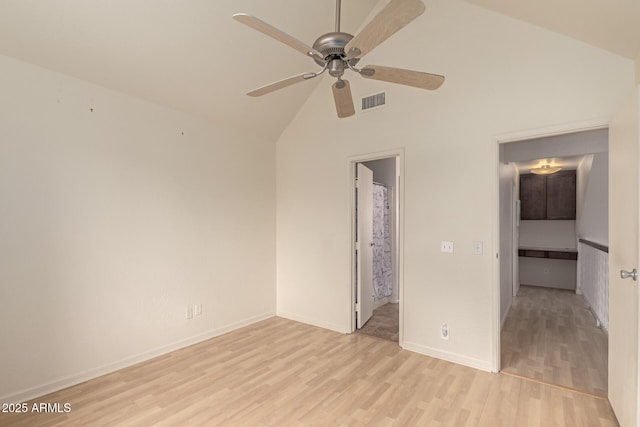 unfurnished bedroom featuring visible vents, ensuite bathroom, baseboards, high vaulted ceiling, and light wood-style flooring