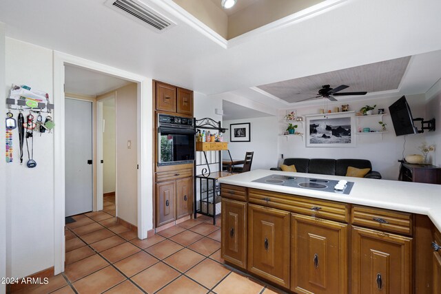 kitchen with white electric stovetop, ceiling fan, light tile floors, and black oven