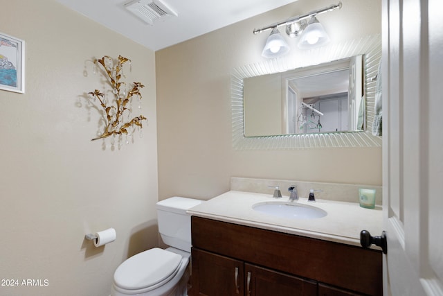 bathroom featuring toilet and large vanity